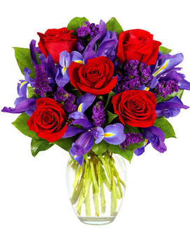 RED ROSES AND IRIS BOUQUET - Rubies are red...and so are the roses in this romantic arrangement all set to take someone's breath away. Purple statice, blue iris and a lovely clear garden vase also contribute effortlessly to a look of total beauty.