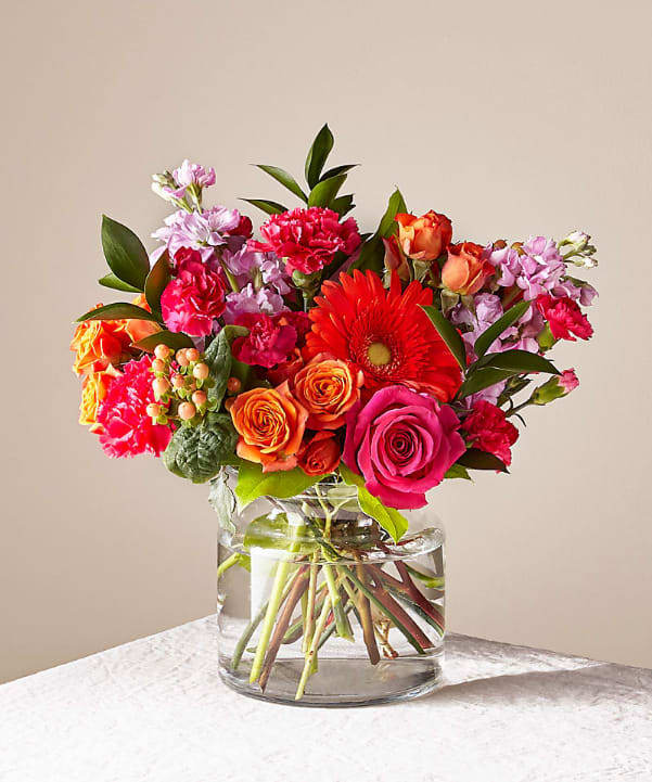 Fiesta Bouquet - The Fiesta Bouquet is composed of a lively mix, fit to celebrate any and every moment. With a combination of vibrant flowers, this florist–designed arrangement brings a pop of color and a burst of excitement as soon as it arrives