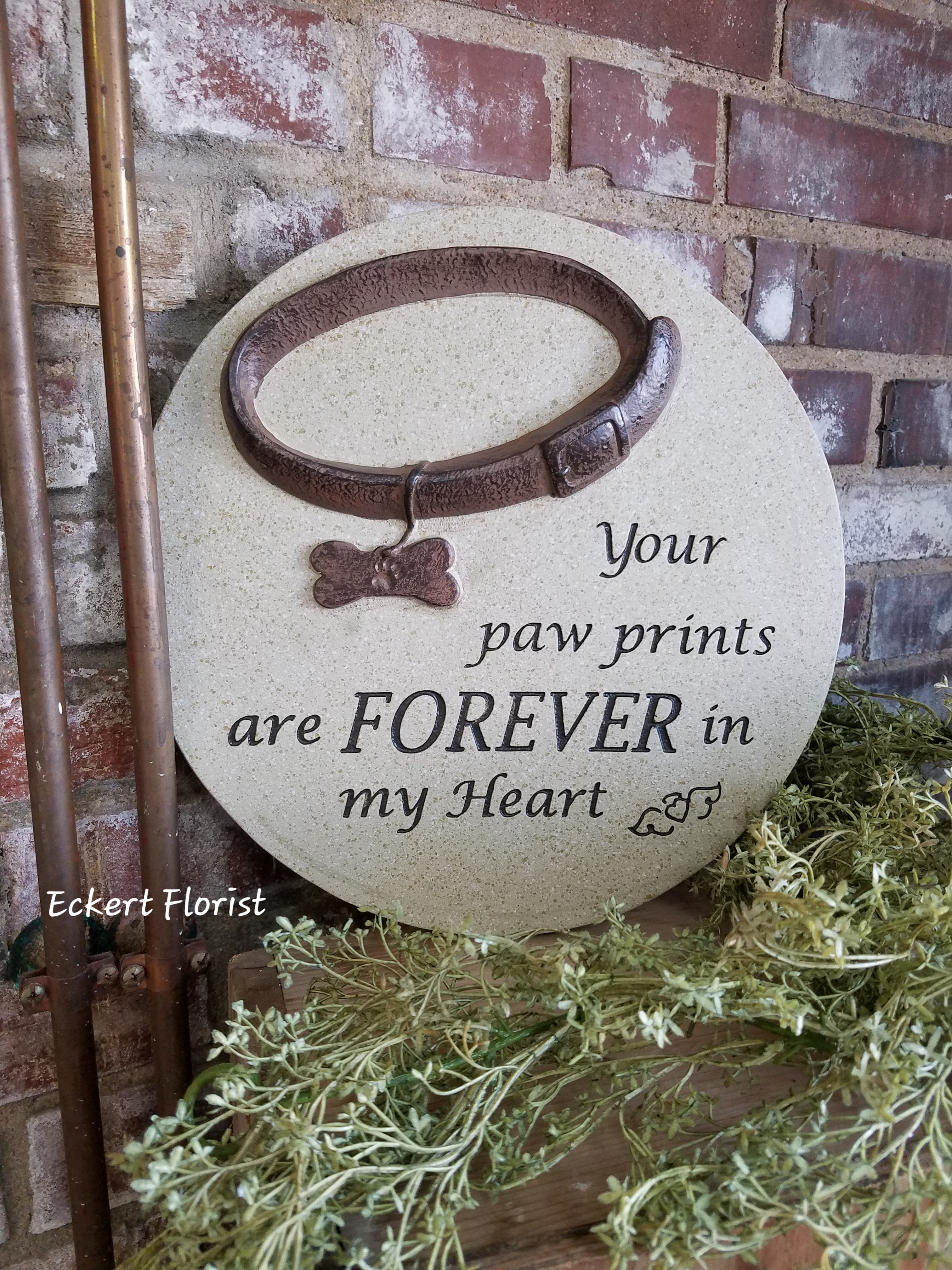 Eckert Florist's Pet Collar Memorial Stone *LOCAL DELIVERY ONLY Eckert Florist's Pet Collar Memorial Stone *LOCAL DELIVERY ONLY - This resin stone is a perfect memorial keepsake for a beloved canine. Approx. 12" diameter *May be added to a fresh arrangement or green plant. See Deluxe and/or Premium upgrades. *See Add-on Section for Display Easel