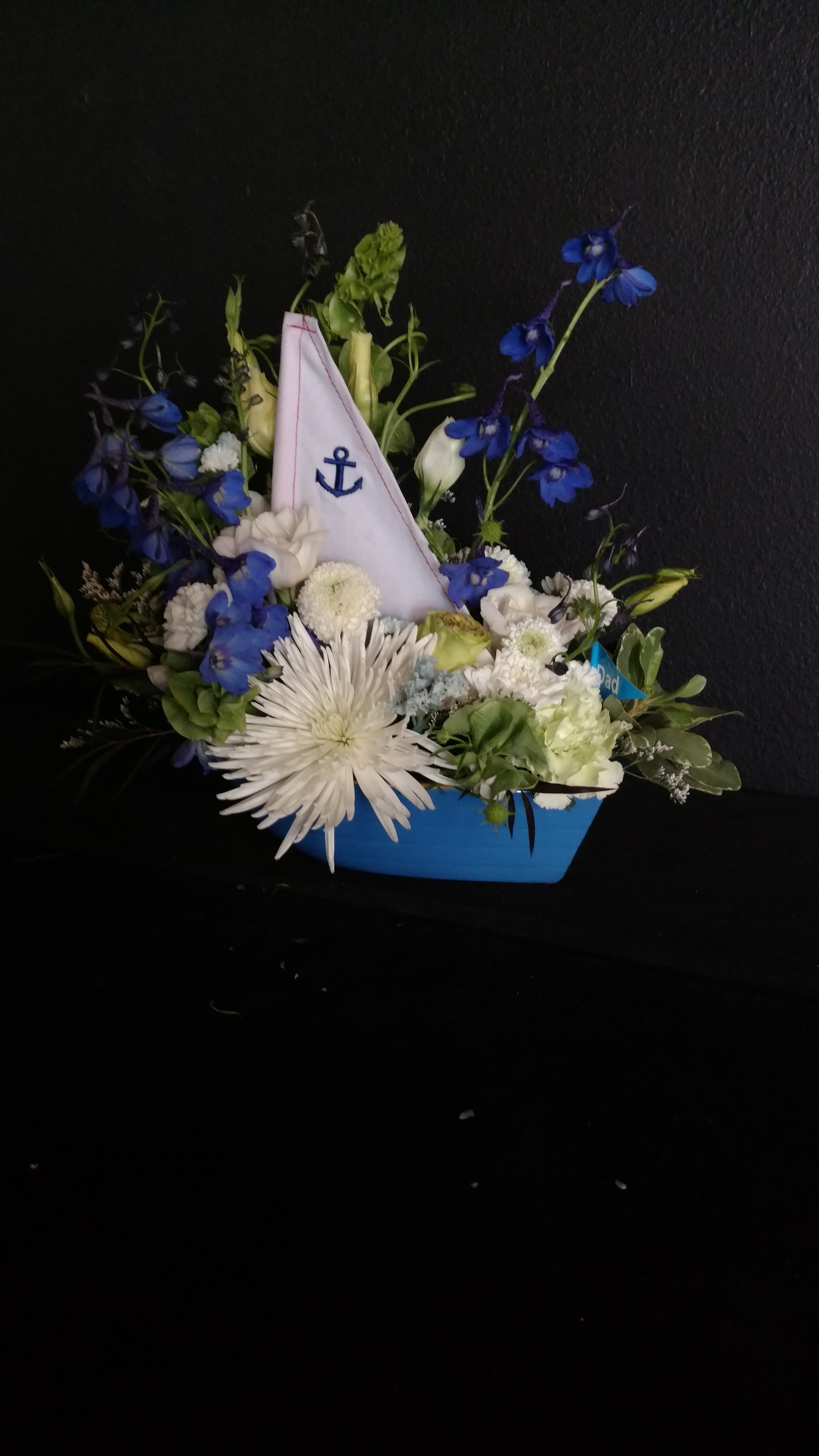 Smooth Sailing - White and blue flowers to complement a ceramic sail boat.