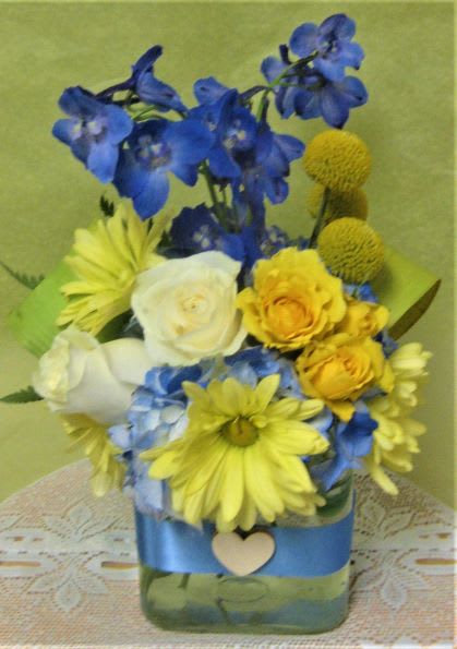 Sun and Sky - Blues and white with yellow florals for a pop of sunshine and blue skies!  Add your occasion mylar balloon to bring this arrangement to a heavenly high.