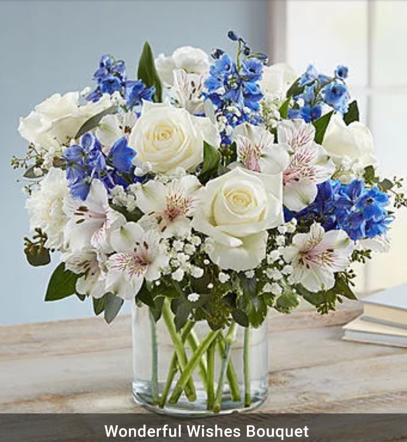 Wonderful wishes bouquet - Mixture of white flowers with a blue flower accent in a clear vase all around arrangement 12x12.   (on this website photo shows all the flowers in front but we will create all around design, some of the flowers won't show in front when your friend take photo.)