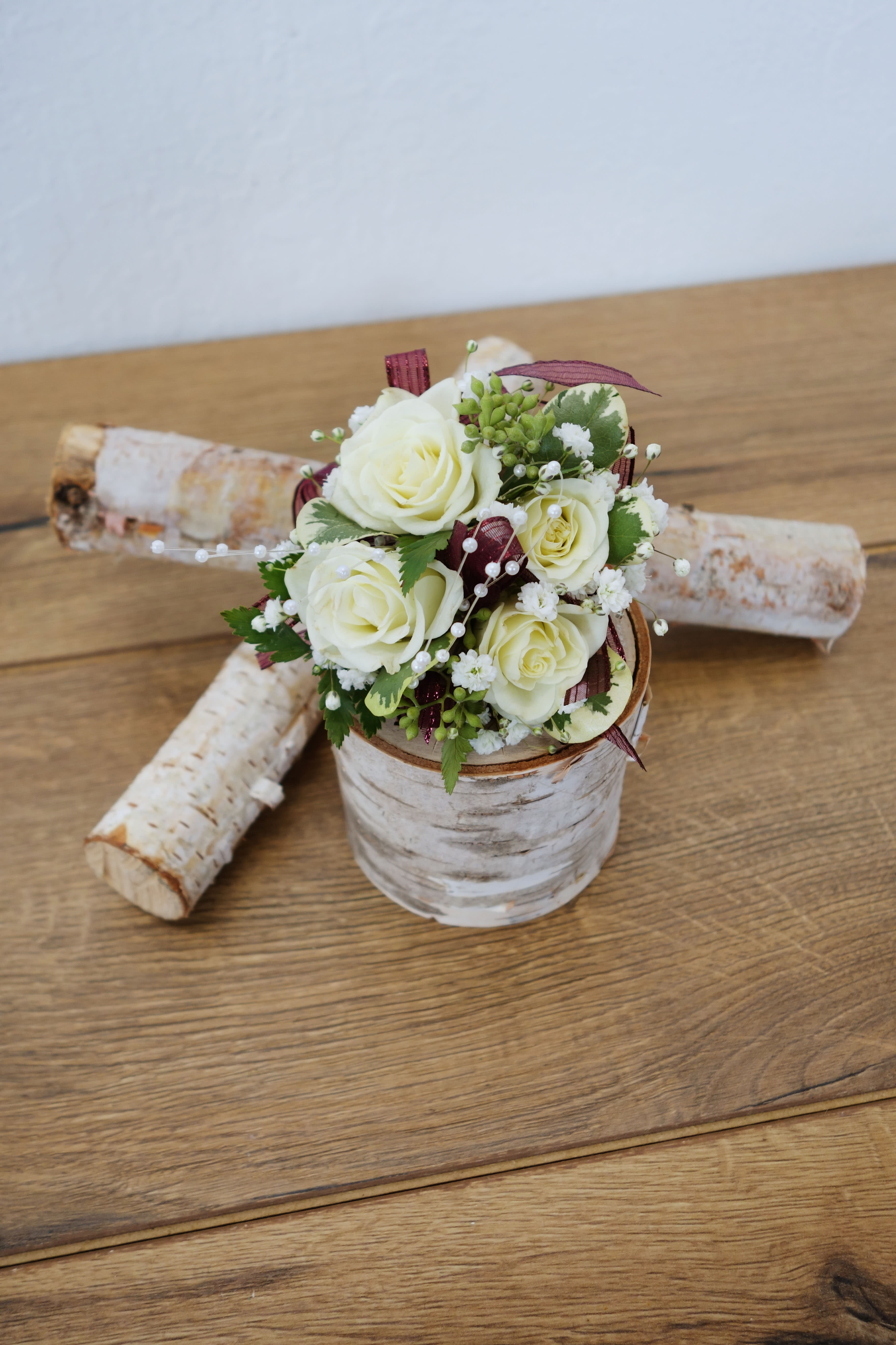 C#02 White Spray Rose Corsage (Pre-Order Item) - Choose classic white roses with baby's breath and mixed foliage that matches any color scheme for formal, prom and event.   **According to your needs ribbon color can be replaced to others.  **This is a special order, please order 3-5 days in advance (no next day or same day pick up order). Please call our store if needed within 3 days.