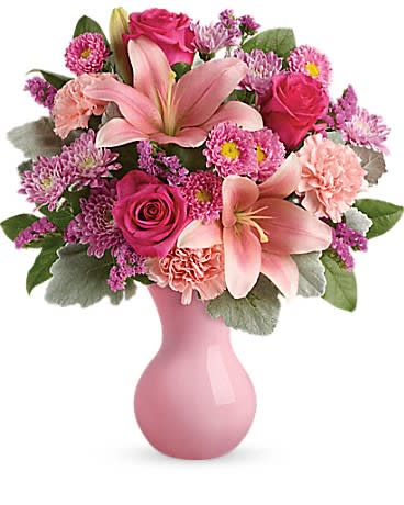 Teleflora's Lush Blush Bouquet - Inspired by the beautiful blush of happy cheeks this fabulous mix of roses lilies and carnations presented in a pink keepsake vase will make them feel like the extra special person they are!