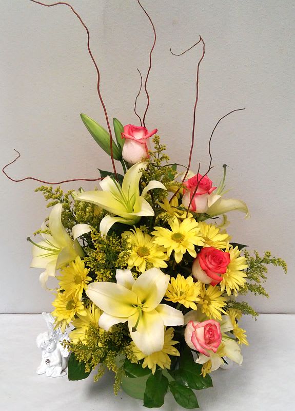 Sunshine Splendor - Bright-yellow lilies and fire-orange roses awaken the senses with sunny greetings for any occasion. Brighten someone's day today!