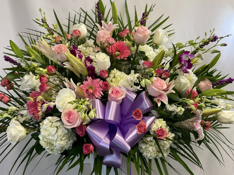 Peaceful Memories Arrangement Peaceful Memories Arrangement - A beautiful sympathy arrangement featuring flowers in many shades of pink. The handled basket holds pink gladiolus, pink roses, pink snapdragons, pink carnations and more. Appropriate to send to a home or to a funeral.