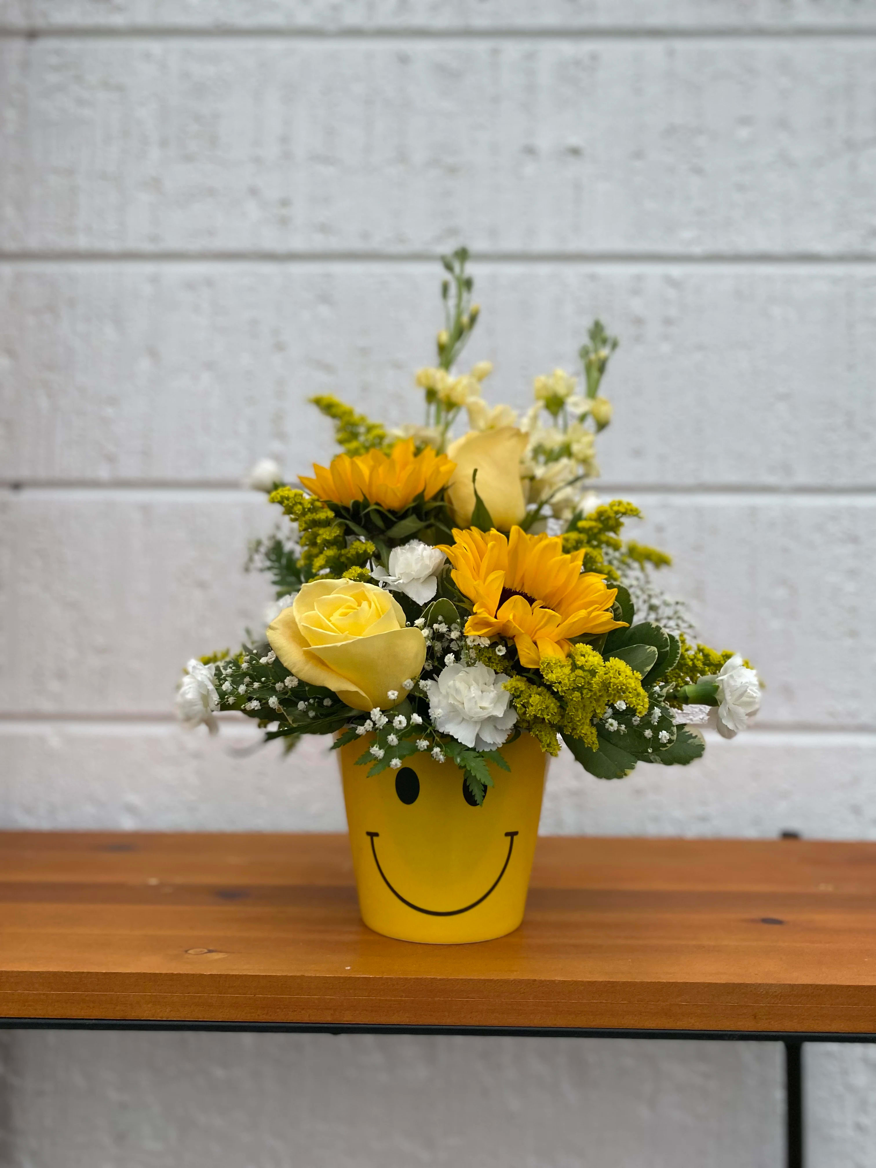 Miles of Smiles - A cheery mix of bright, colorful flowers in a Smiley Container! Just the floral arrangement to put a smile on someone's face!