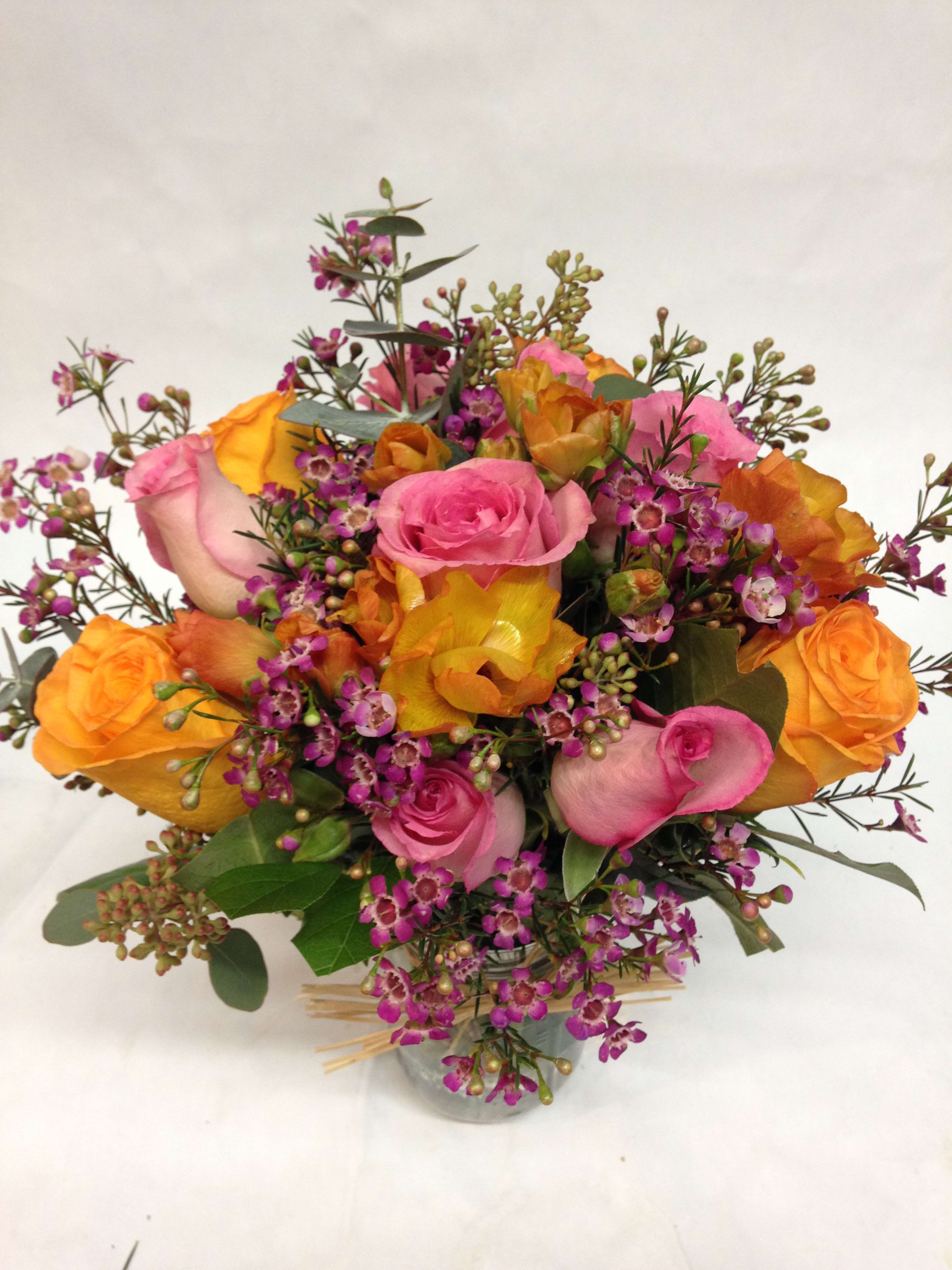 Spring warm garden jar Spring warm garden jar - A bright mix of orange and pink roses is complimented by bright, happy filler flowers and greens. (Some flowers may be subject to change depending on the season. We will contact you with available flower substitutions; please contact us with specific questions if you are concerned with flower availability, thanks!) Featured Arrangement: $100.00 (Regular Price)
