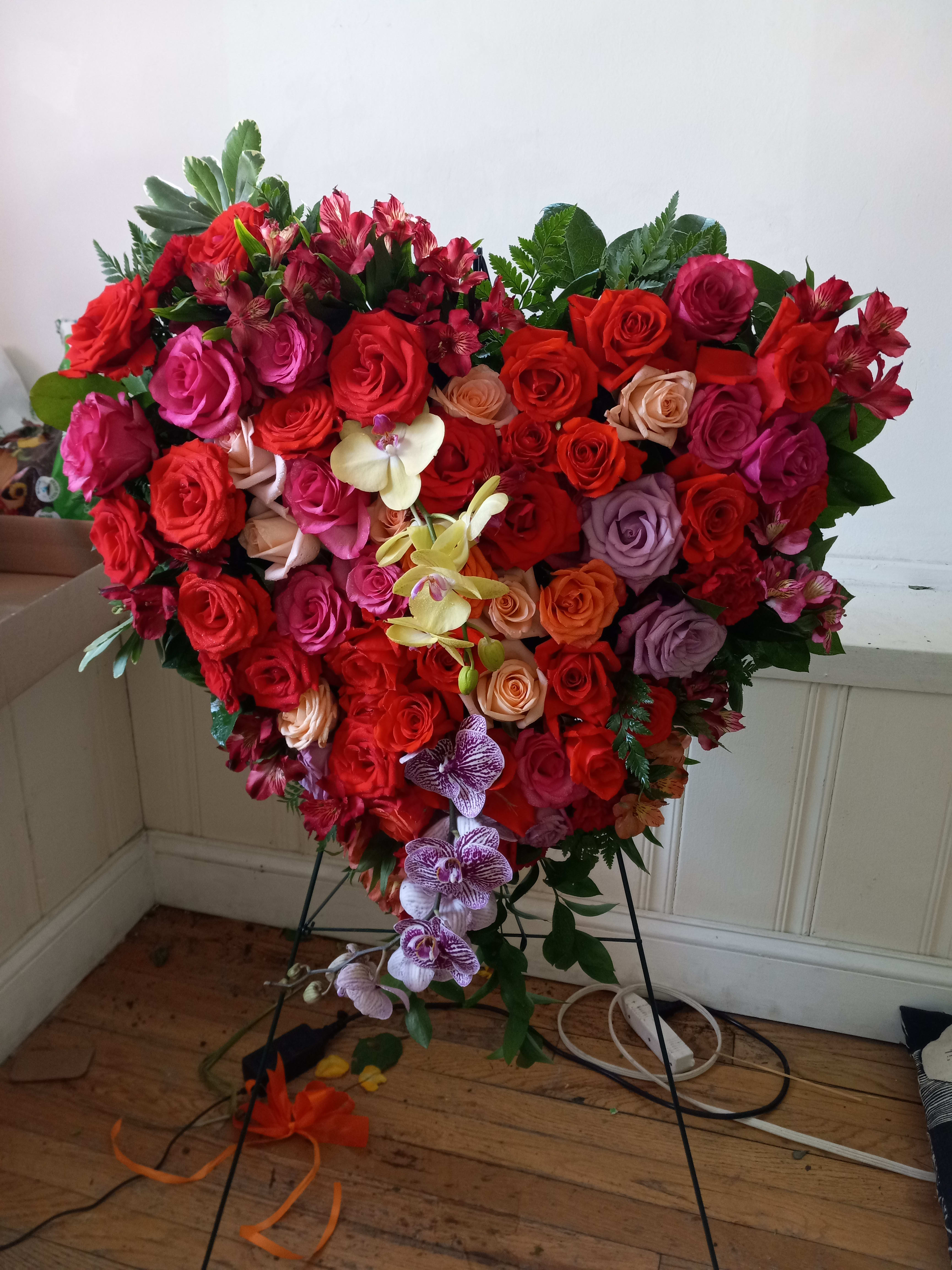 &quot;Bleeding heart&quot; standing spray - All roses, carnations and orchids &quot;Bleeding heart&quot; standing spray made of mixed color roses and two orchids 
