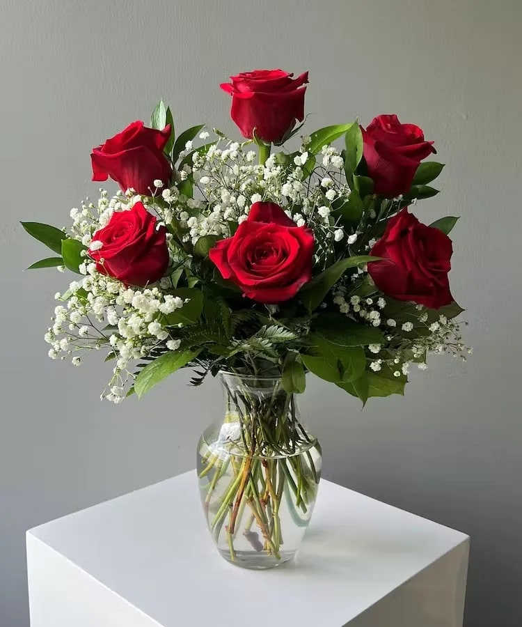 Roses, Baby Breath and Greens - Six Roses in a vase with a variety of greens and baby breath