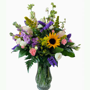 Melange Jardin - A garden arrangement of mixed flowers...that is what the name means...  Shown here in a clear vase with sunflowers, lisianthus, roses, stock, etc.  The mix is what makes it look so luxurious. Your arrangement will be similiar, depending upon flower availability.