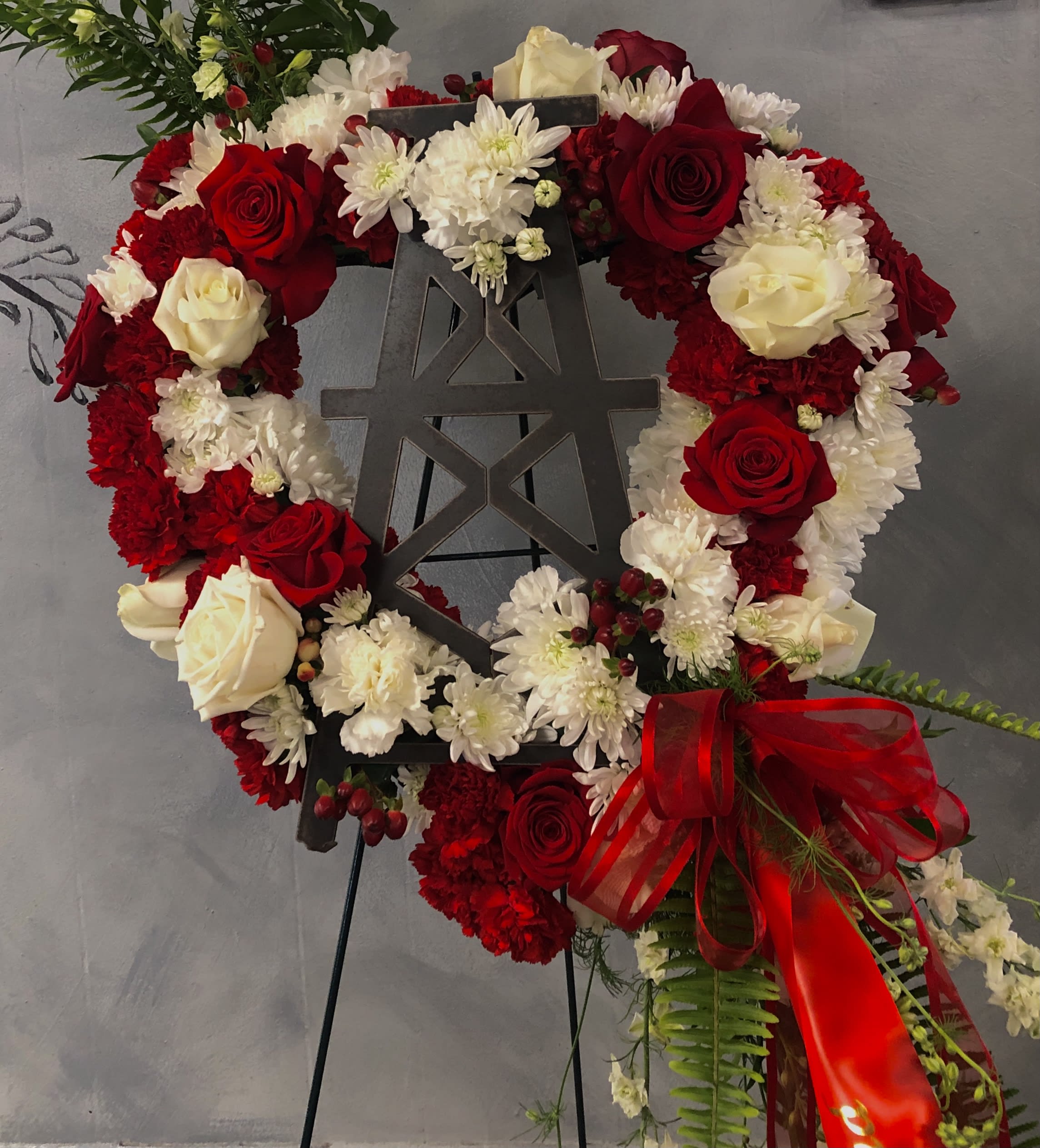 Red and White Oilfield Heart Sympathy Wreath - Please Call Before Ordering! This type of arrangement sells out often faster than we can pull it off the site. We'd love to customize it for you according to what was important to your loved one. 