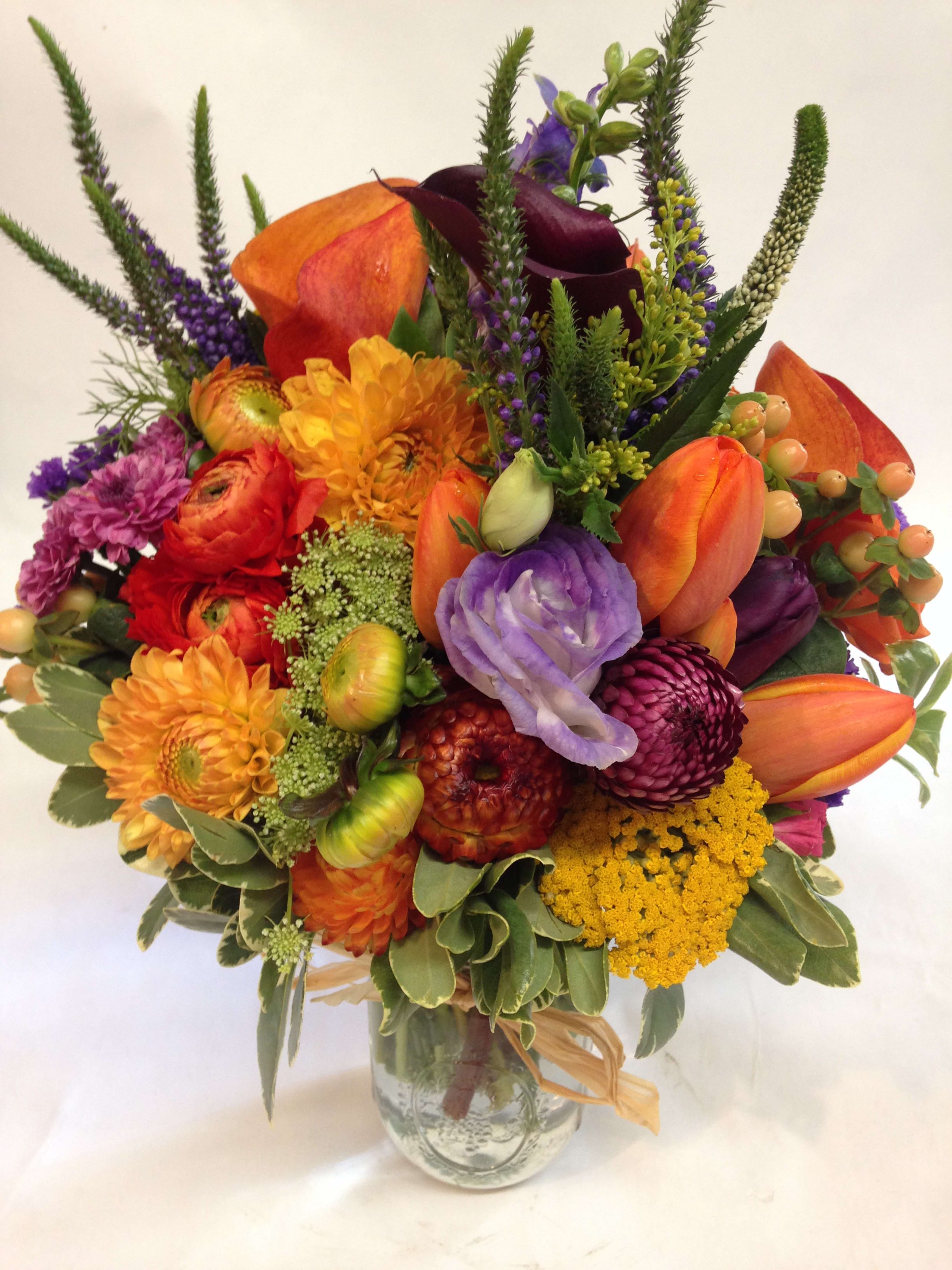 Vibrant Garden Jar Vibrant Garden Jar - A vibrant and festive arrangement worthy of the Noe Valley neighborhood! Featuring bright spray roses, tulips, hypericum, purple color flowers, seasonal filler and greenery. Comes in a rustic mason jar. (Some flowers may be subject to change depending on the season. We will contact you with available flower substitutions; please contact us with specific questions if you are concerned with flower availability, thanks!) Featured Jar: $125.00