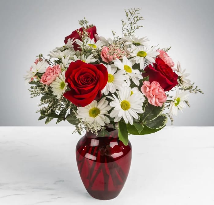 Boldly Bashful by BloomNation™ - This bouquet is a sweet way to show someone you care. Boldly Bashful by BloomNation™ is a great gift for Valentine's Day or Birthday.   Arrangement Details: Includes white chrystanthemum spray daisies, pink carnations, and red roses.  APPROXIMATE DIMENSIONS: 12&quot; H X 10&quot; W