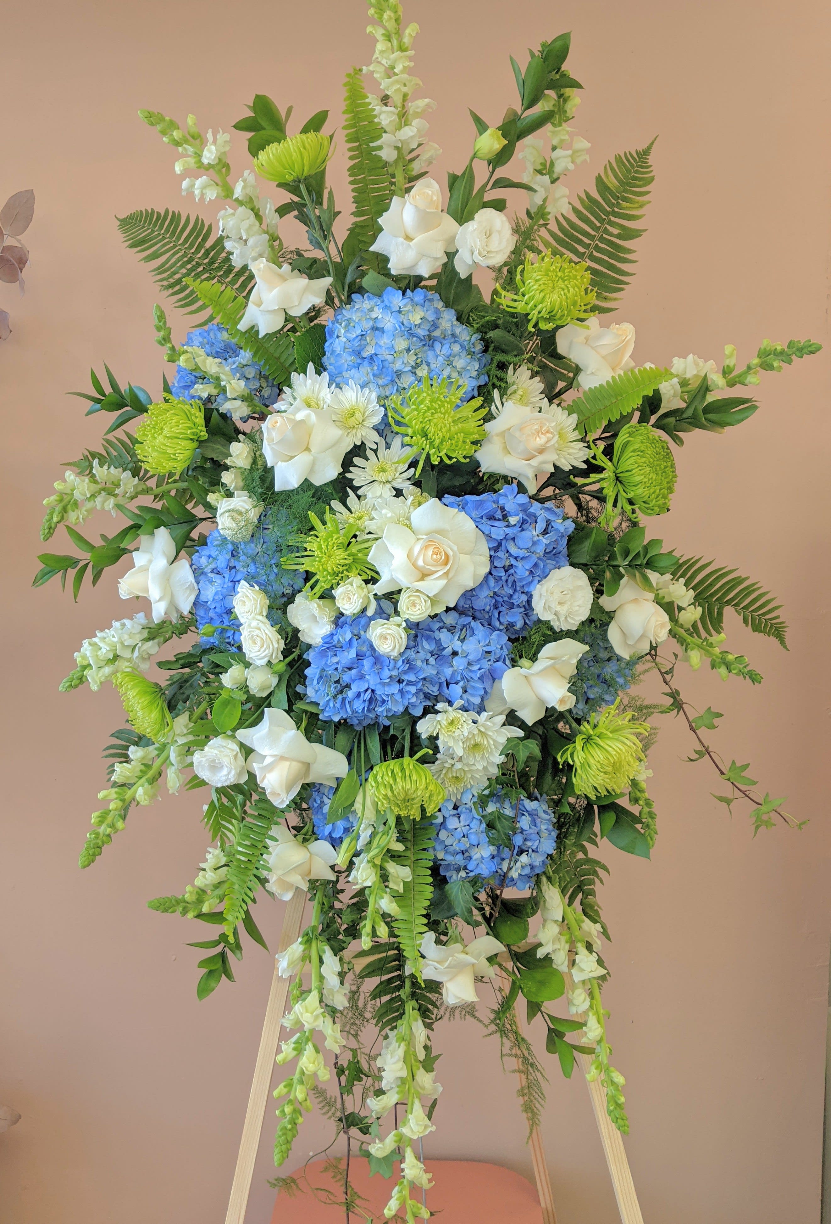 Eternal Peace Standing Spray - A standing spray with hydrangeas, roses, spray roses, spider mums, snap dragons, lisianthus and greens. Option to change color palette or add a ribbon- please note under SPECIAL INSTRUCTIONS 