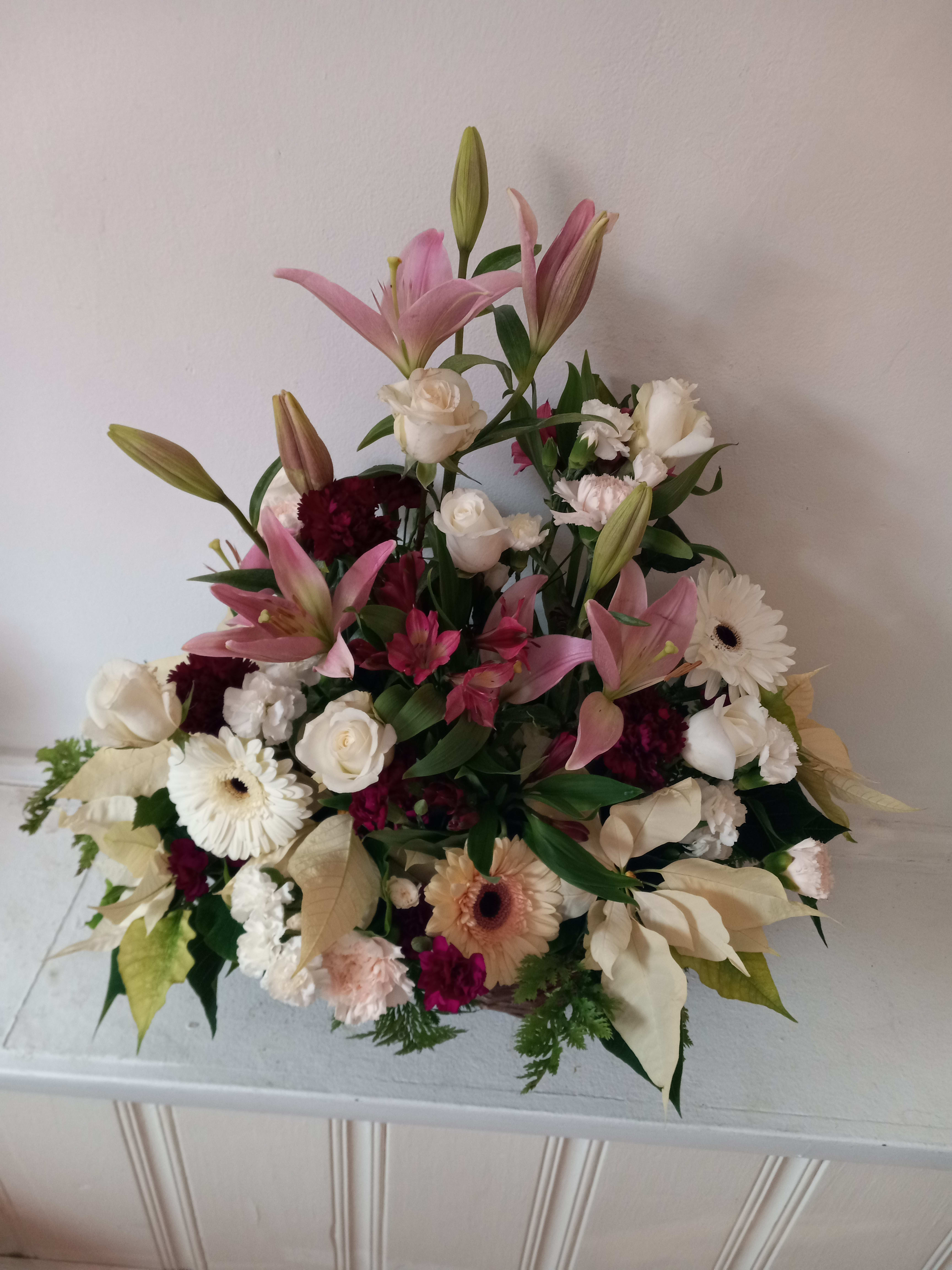 &quot;Irene&quot; Sympathy basket - Inspired by loss of a loved one on a verge of a Holiday season this funeral basket contains white Poinsettia and pastel color varied flowers. 