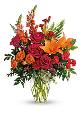 Bold Sunset - Sunset-inspired color, this bold, beautiful blend of hot pink roses and orange lilies in a classic glass vase will be a perfect ending to a perfect day.