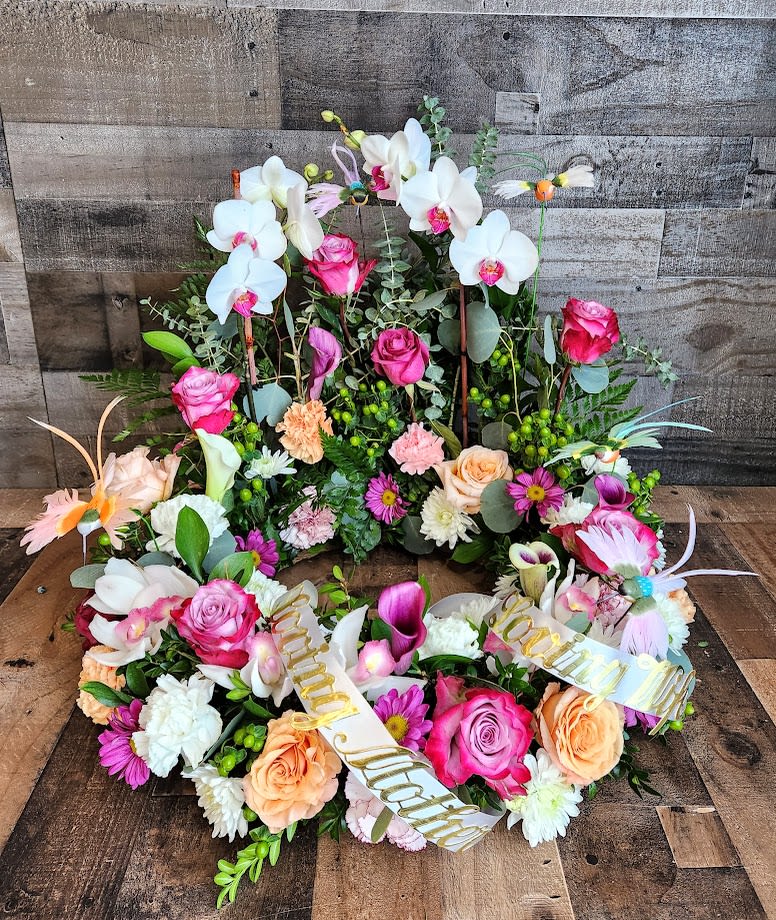 Hummingbird Urn Wreath Hummingbird Urn Wreath - *We custom design this arrangement and use the freshest flowers available the day of delivery. The arrangement in this picture is an example of the size and style and may not feature the exact product shown.*
