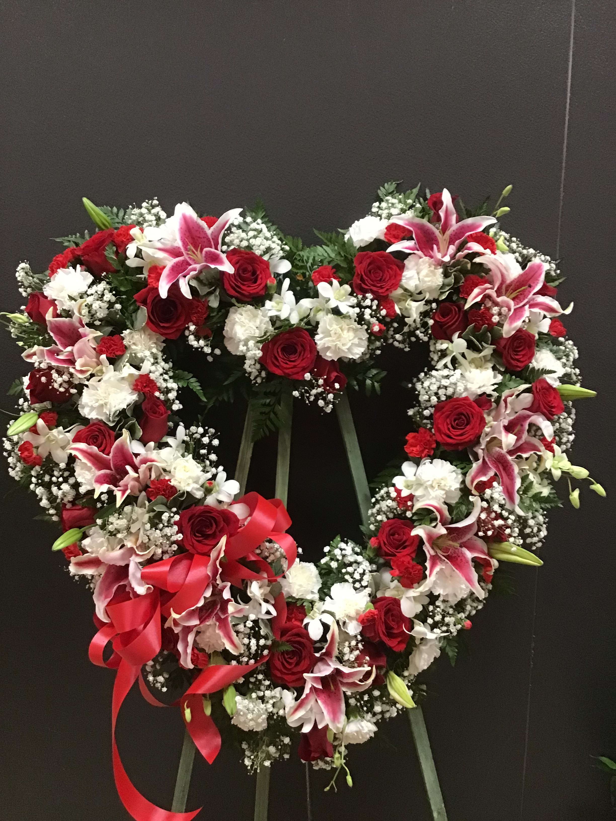 Red and white open heart (FH3) - This standing open heart is make with red and white color flowers  carnations, roses, and lilies and orchid and baby breath 