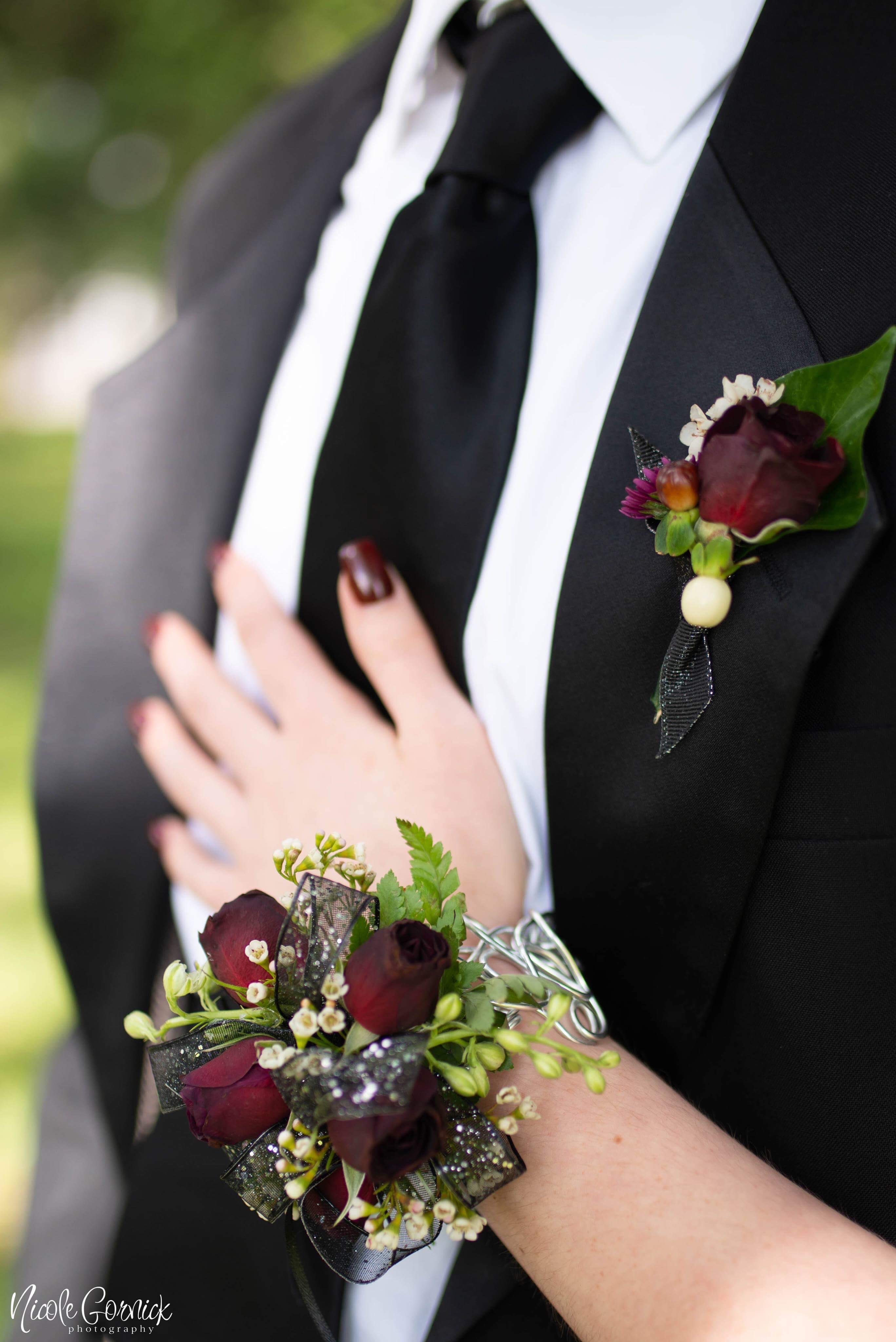 Wrist corsage and butonniere Set Wrist corsage and butonniere Set - Matching set of wearable flowers for the couple... specify color shade or send us a picture of the color to coordinate. Shown in deluxe
