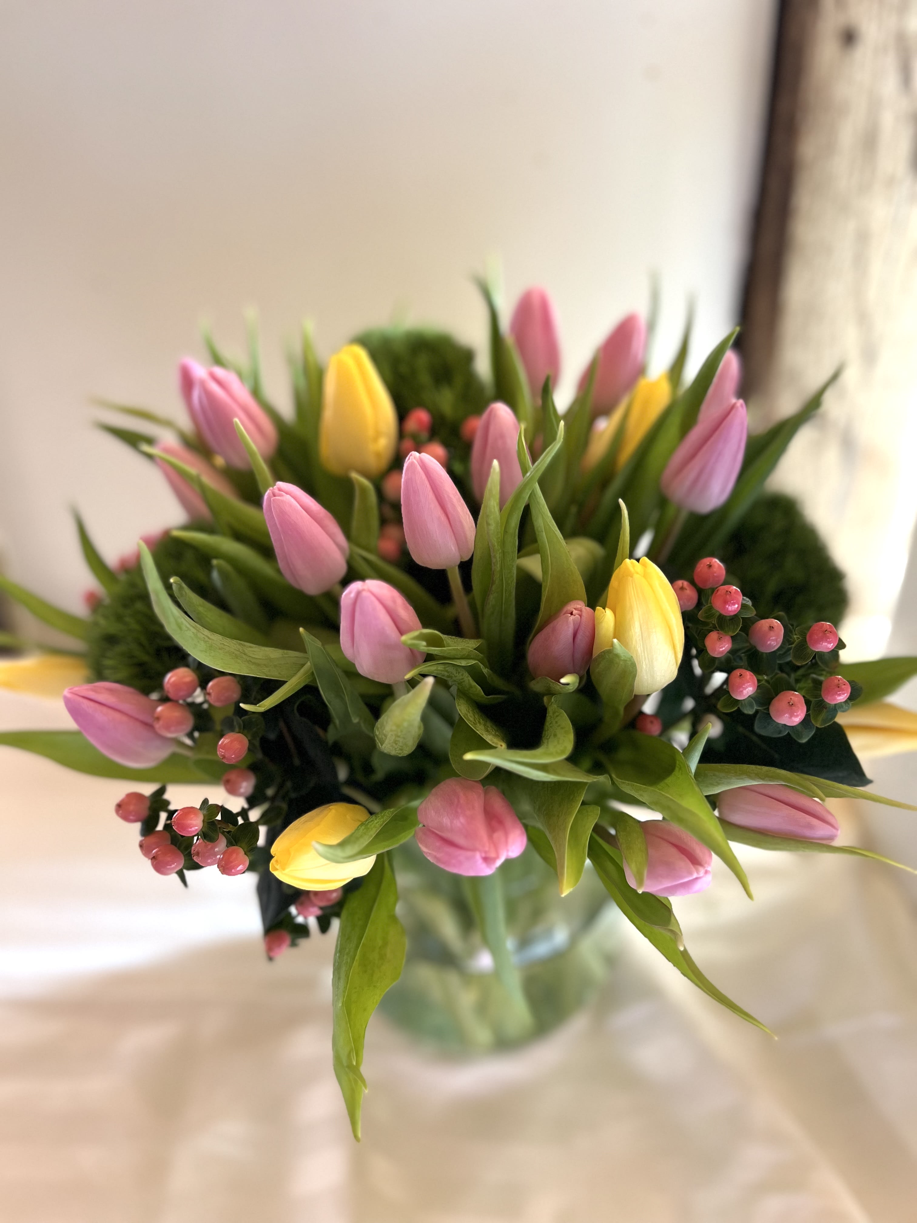 For the lovers who love Tulips For the lovers who love Tulips - A rather generous serving of yellow and pink tulips accented with berries spring green dianthus
