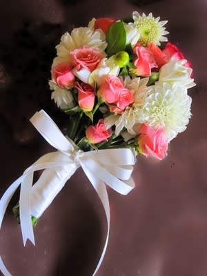 Pink & White Hand Tied Bouquet Pink & White Hand Tied Bouquet - Pink & White Roses,Pink Spray Roses, and Beautiful White Dahlias make this an eye-catching bouquet. Hand -tied and wrapped with a White Silk Ribbon.