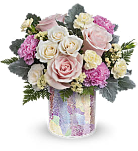 Rosy Quartz Bouquet - Sweet as a kiss, Teleflora's Rosy Quartz Bouquet is a precious pink arrangement in an iridescent mosaic glass vase perfect for your next celebration! This arrangement includes pink roses, white spray roses, pink carnations, miniature light yellow carnations, light yellow sinuata statice, dusty miller and leatherleaf fern. This pastel bouquet is delivered in Teleflora's Radiantly Rosy Cylinder. Approximately 13 1/4&quot; W x 12 1/2&quot; H
