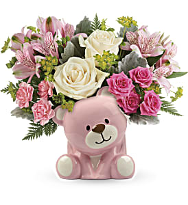 Precious Pink Bear Bouquet by Teleflora - Honor a precious arrival with gorgeous cream roses and delicate pink blooms, beautifully bundled in a sweet ceramic teddy bear keepsake.  Let us know if the order notes: BLUE OR PINK