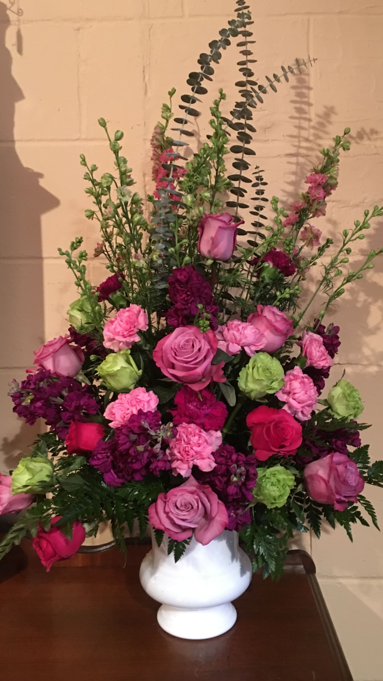 A sweet Rememberance  - All shades of purple and pink roses, green hydrangea, pink lark, pink stock, pink and plum carnations 