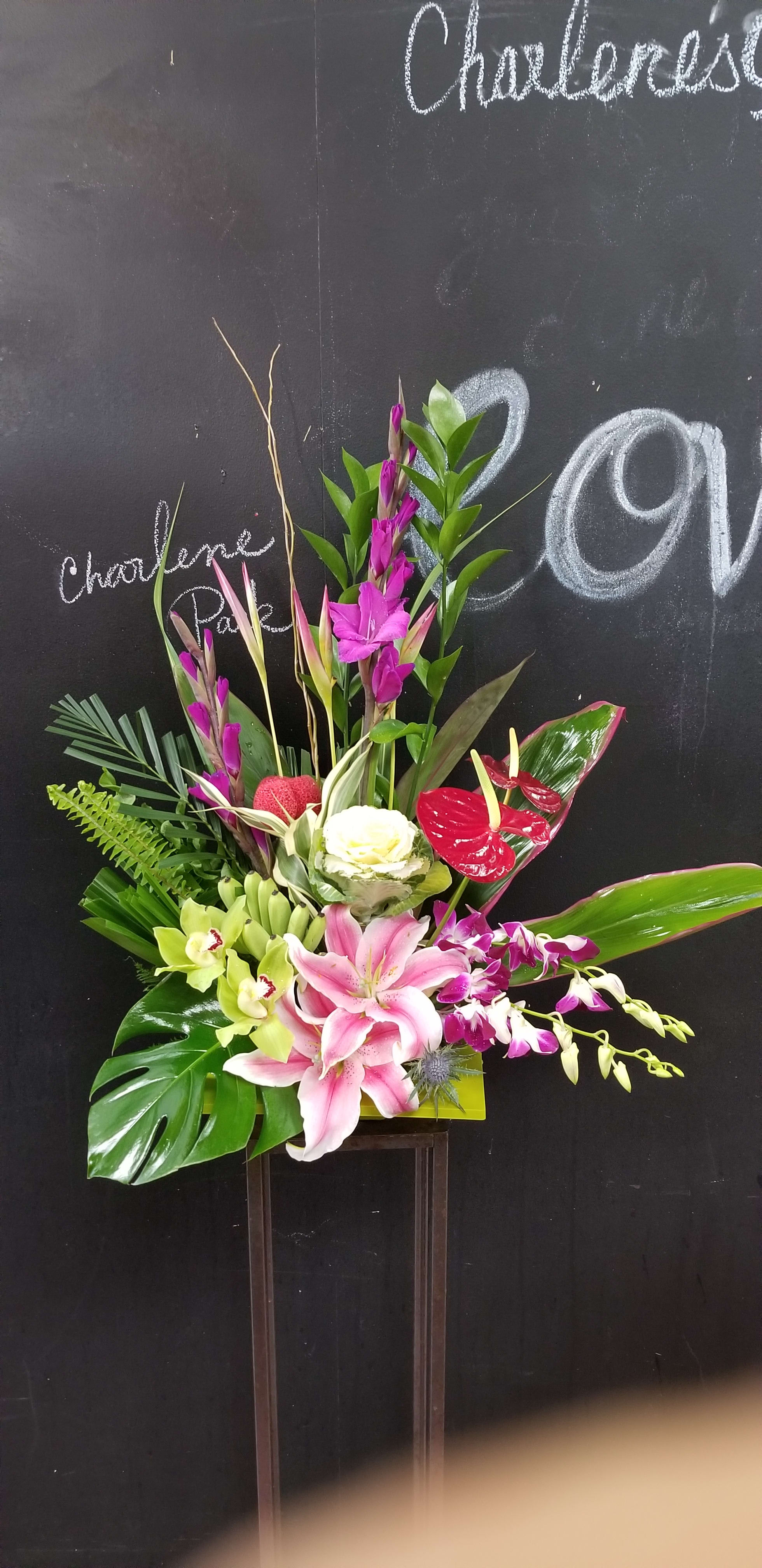 Hawaiian hugs and kisses - This Hawaiian hugs and kisses Arrangement including tropical flowers like ginger, protea, heliconia and tropical foliage arranged nicely with stargazer lily and dendrobium orchids for tropical flower lovers. Flowers can be substituted by availability for that week.