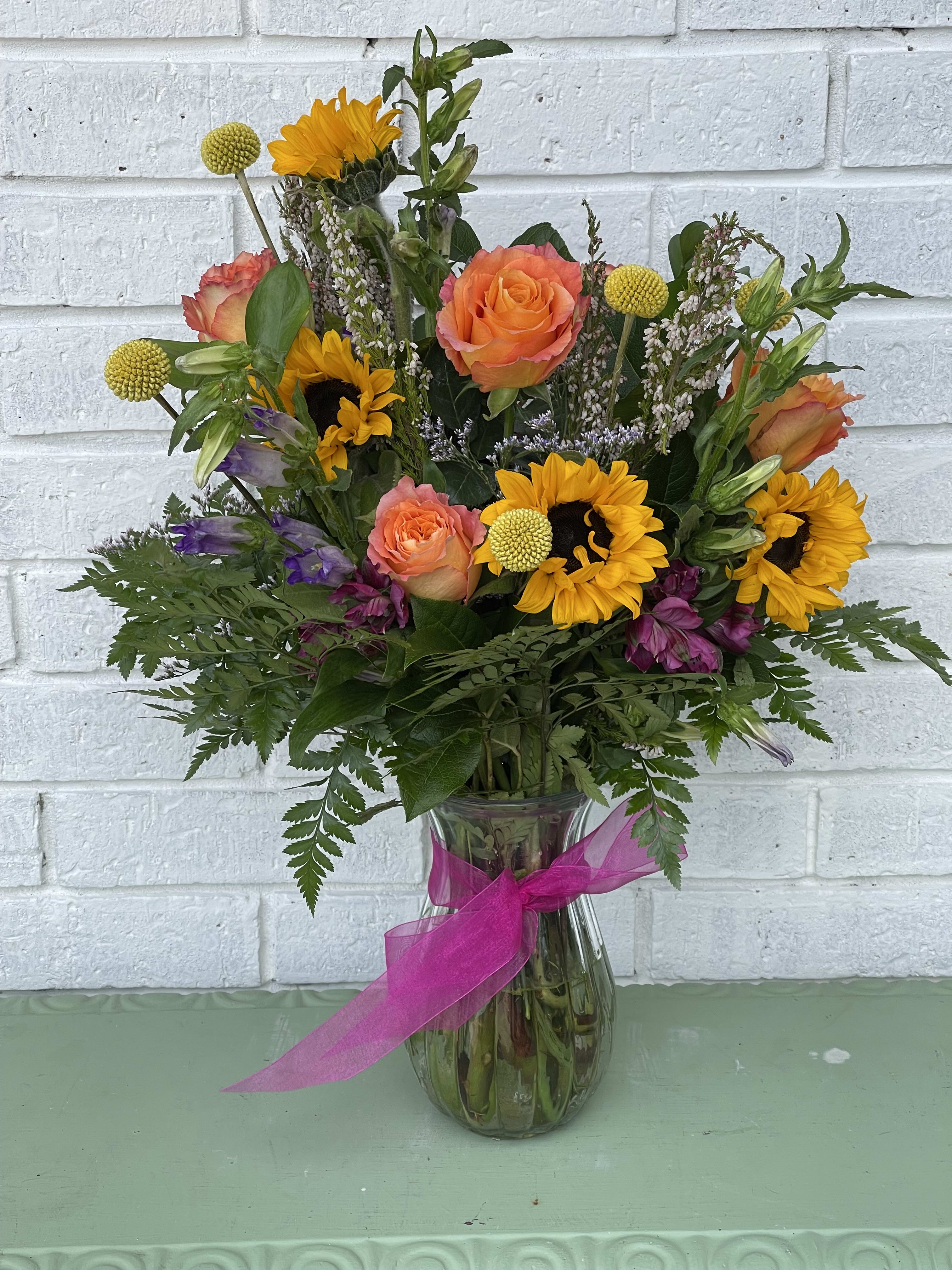 the spring fling garden floral the spring fling garden floral - A beautiful ginger glass vase filled with roses, solidago, sunflowers and a variety of flower mix