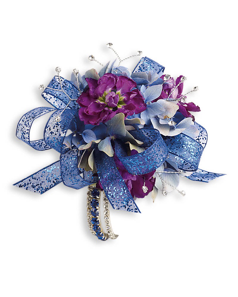 Feel The Beat Corsage - Dance the night away in dark dramatic blue hydrangea and purple stock. Blue hydrangea purple stock and bear grass with rhinestone touches.