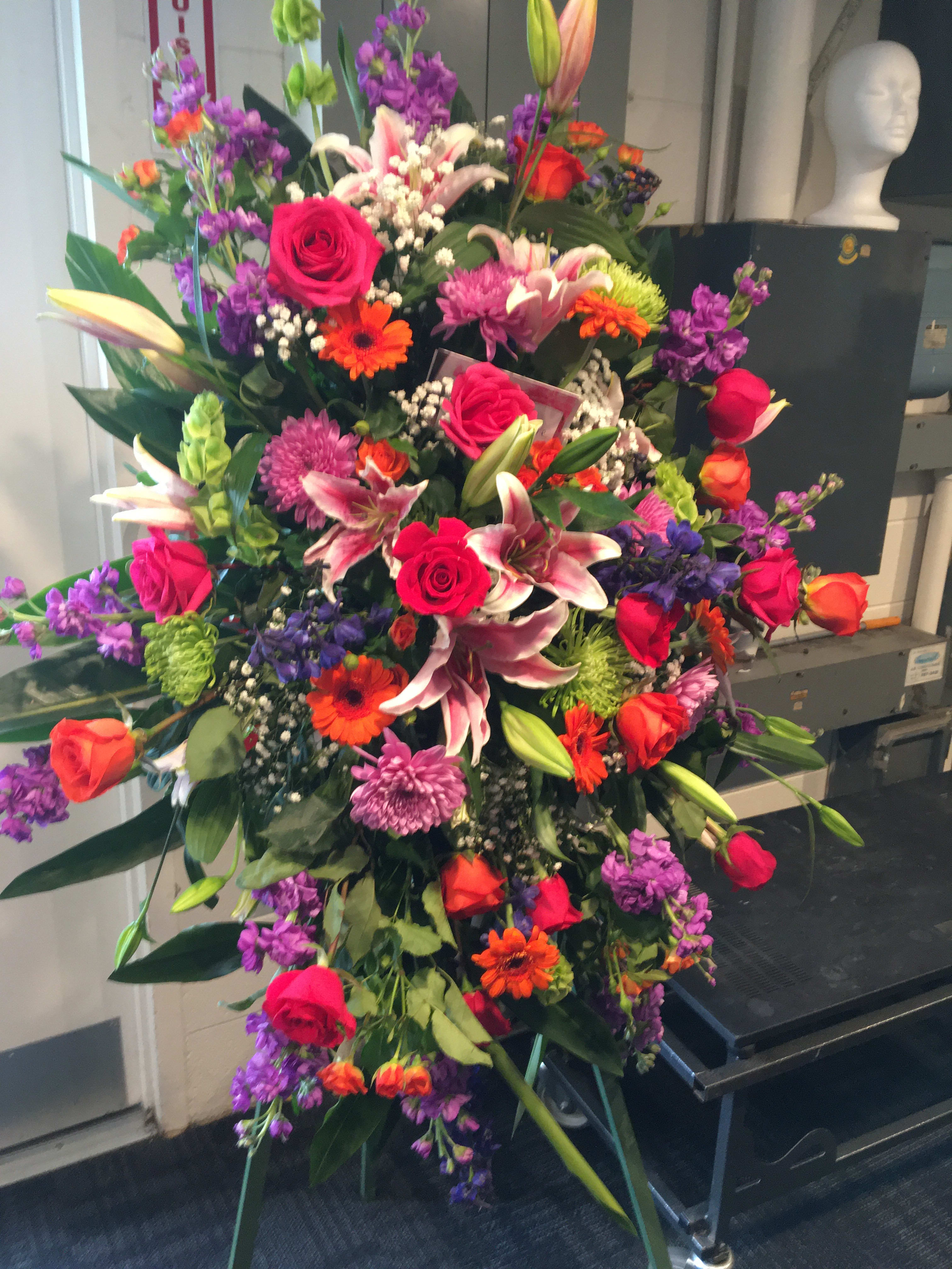 REMEMBERED FOREVER LOVING BLOOMS EASEL- ON SALE WAS $298 REMEMBERED FOREVER LOVING BLOOMS EASEL- ON SALE WAS $298 - A BEAUTIFUL SCENTMENT OF LOVE. ALOHA HAWAIIAN ARRANGEMENT IS DESINGED WITH PINKS, PURPLES, ORANGE AND GREEN BLOOMS -LARGE LILIES, ROSES , BELLS OF IRELAND AND TROPICAL ASSORTED GREENS. ALOHA IS A WORD USED WHEN GREETING OR PARTING AND A DEEPER MEANING OF AFFECTION, PEACE, COMPASSION AND MERCY. SITS ON A FIVE FOOT EASEL.