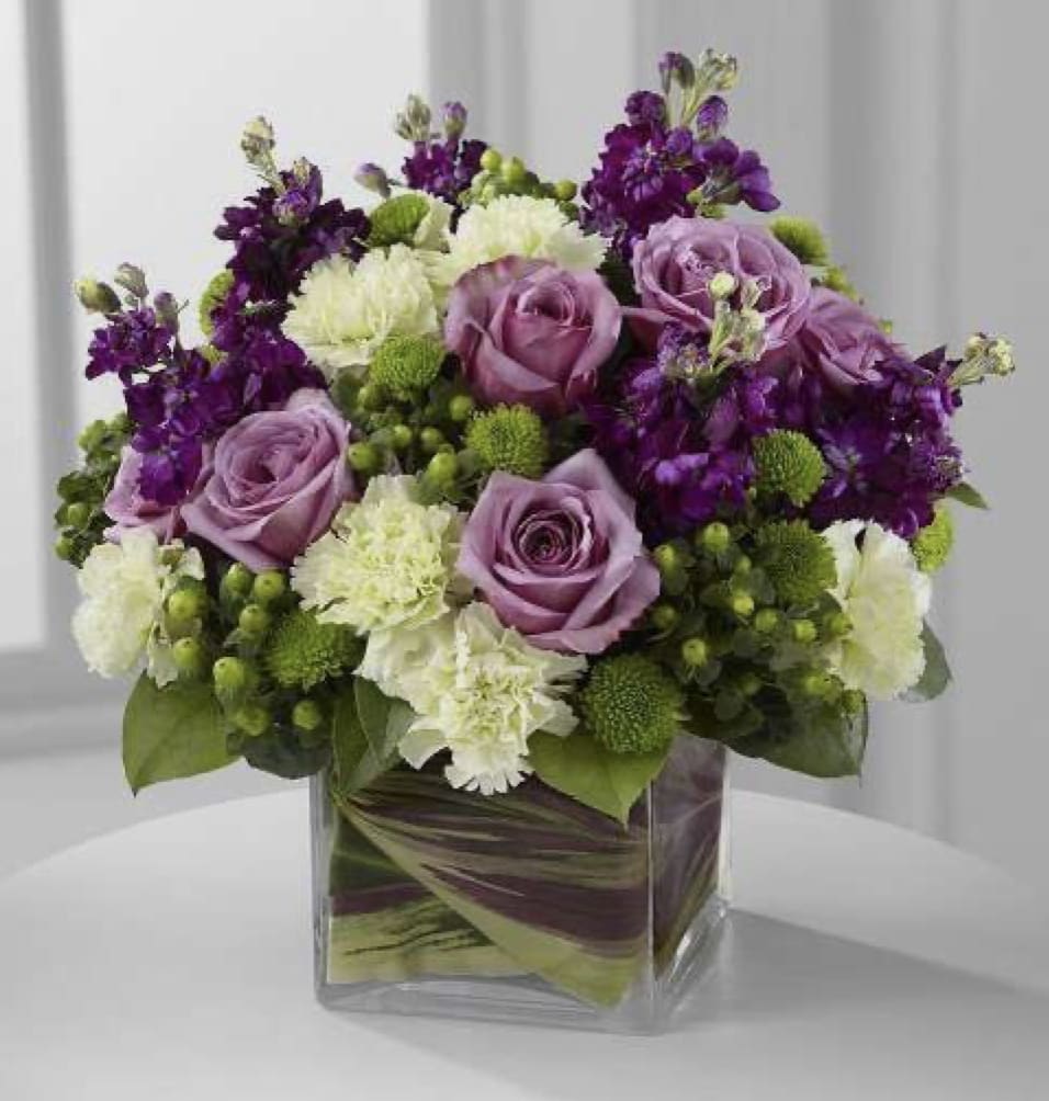 Lavender Centerpiece  - A lavender color centerpiece with roses and other beautiful seasonal flowers 