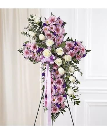 Peace & Prayers Standing Cross Lavender Peace & Prayers Standing Cross Lavender - by our expert florists, is an impressive display made up of soothing lavender blooms in the shape of a cross, and accented with a cascade of white roses and eucalyptus. It is a beautiful way to offer peace and comfort during a difficult time. Arrangement measures approximately 40"H x 26"L