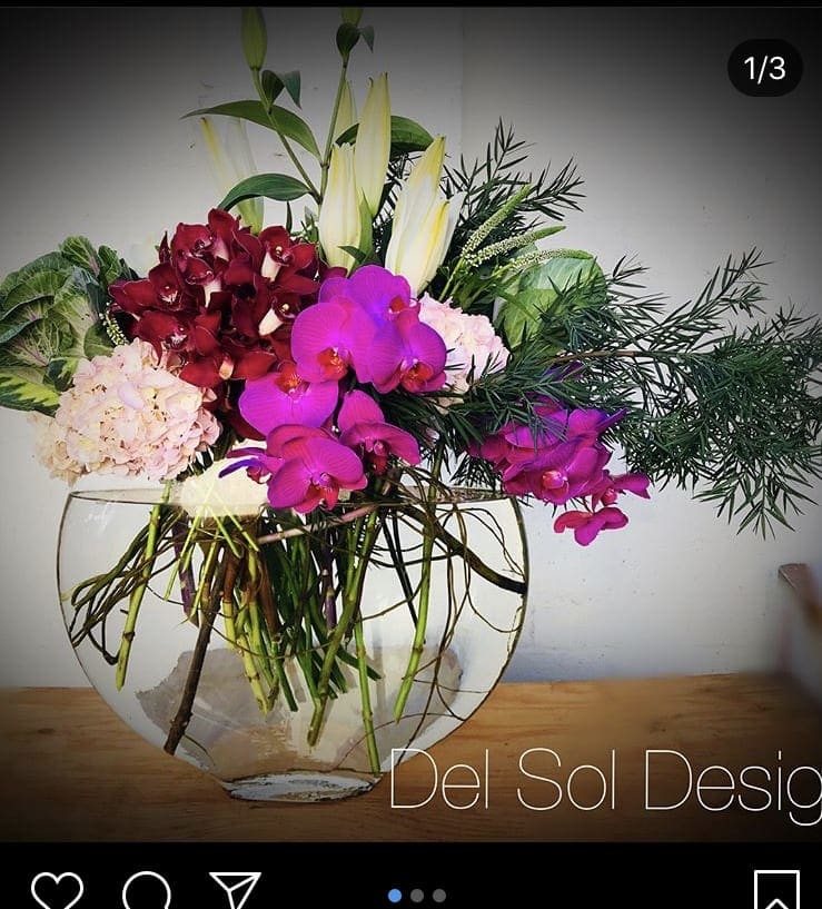 Oval Fishbowl tall - Orchids, roses, greens, hydrangeas, casa blanca, in oval fish bowl. Stunning design for any occasion. Breath taking design.