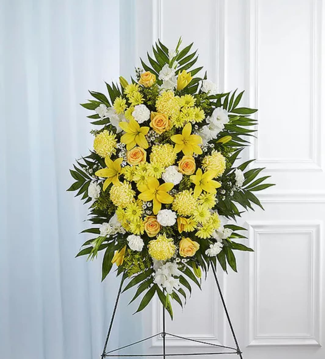 Yellow &amp; White Sympathy Standing Spray - A ray of hope can mean everything after the loss of a loved one. Both bright and abundant, our impressive standing spray arrangement, meticulously handcrafted by expert local florists with sunny yellow and rich white blooms, offers a grand gesture of peace, comfort and light during a difficult time.