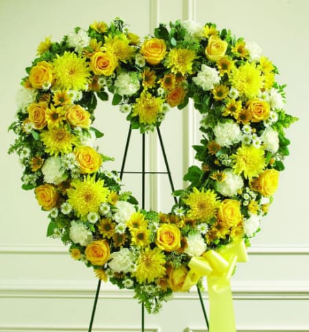 Yellow Sympathy Heart  - Our Yellow Sympathy Heart Wreath is a standing arrangement that is created to lend comfort during a difficult time. Fresh yellow and white blooms are artistically arranged to create a beautiful and heartfelt presentation. A lovely tribute to a dearly departed.