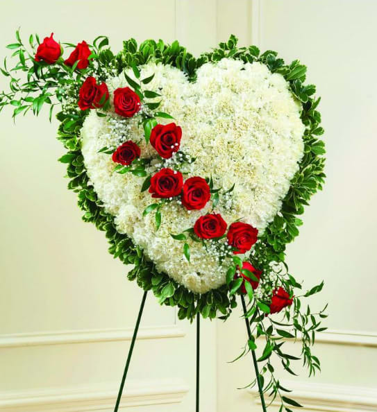 BNRD9 - Solid Sympathy Heart With Red Break Honor a loved one with this standing heart-shaped arrangement that celebrates someone dear. White carnations create a solid heart that is accented with a red rose break. It will be a loving and lasting tribute to a very special person.