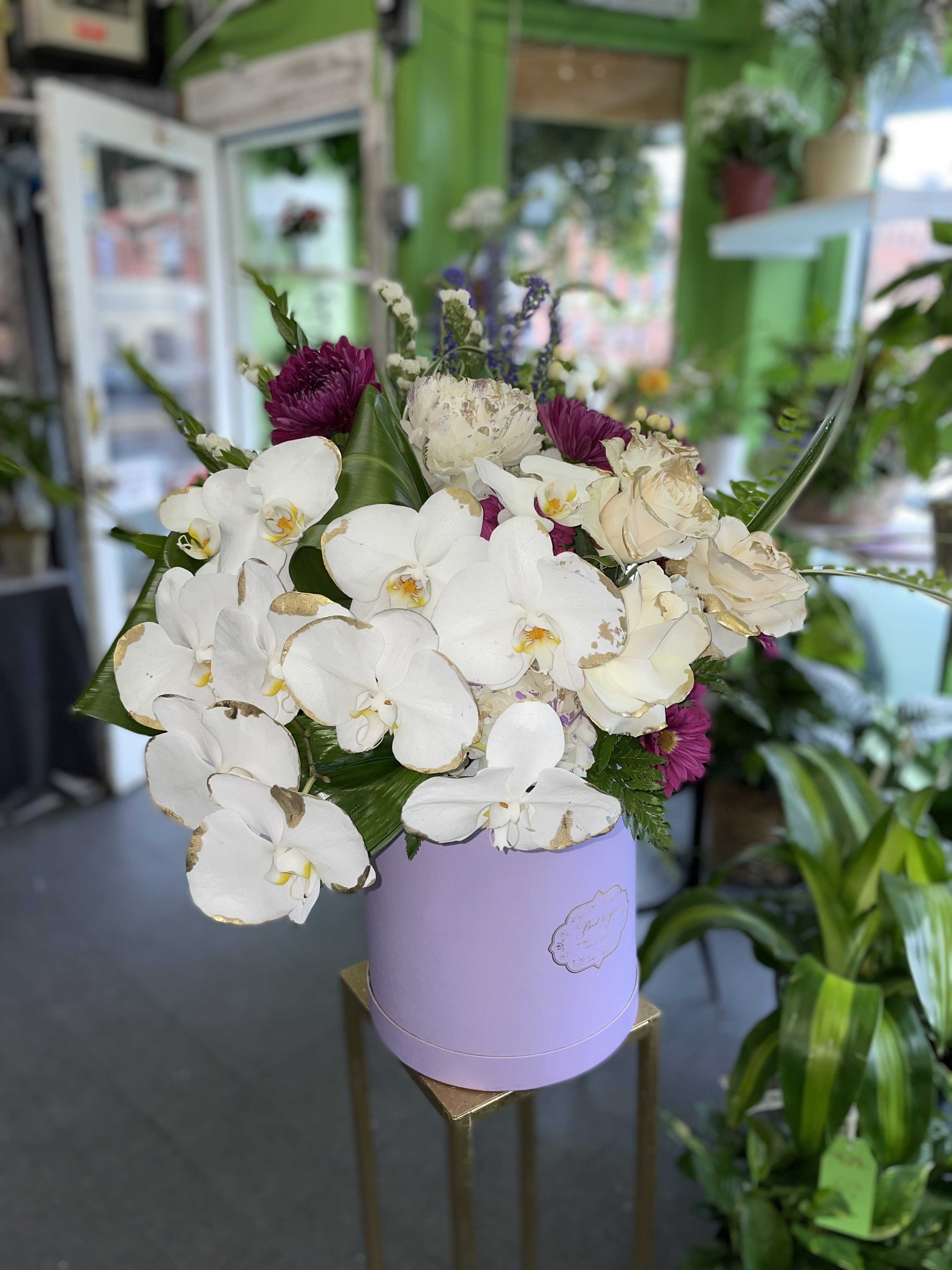 Sweet  - This beautiful arrangement has white orchid, white roses, purple mums, white hydrangea.