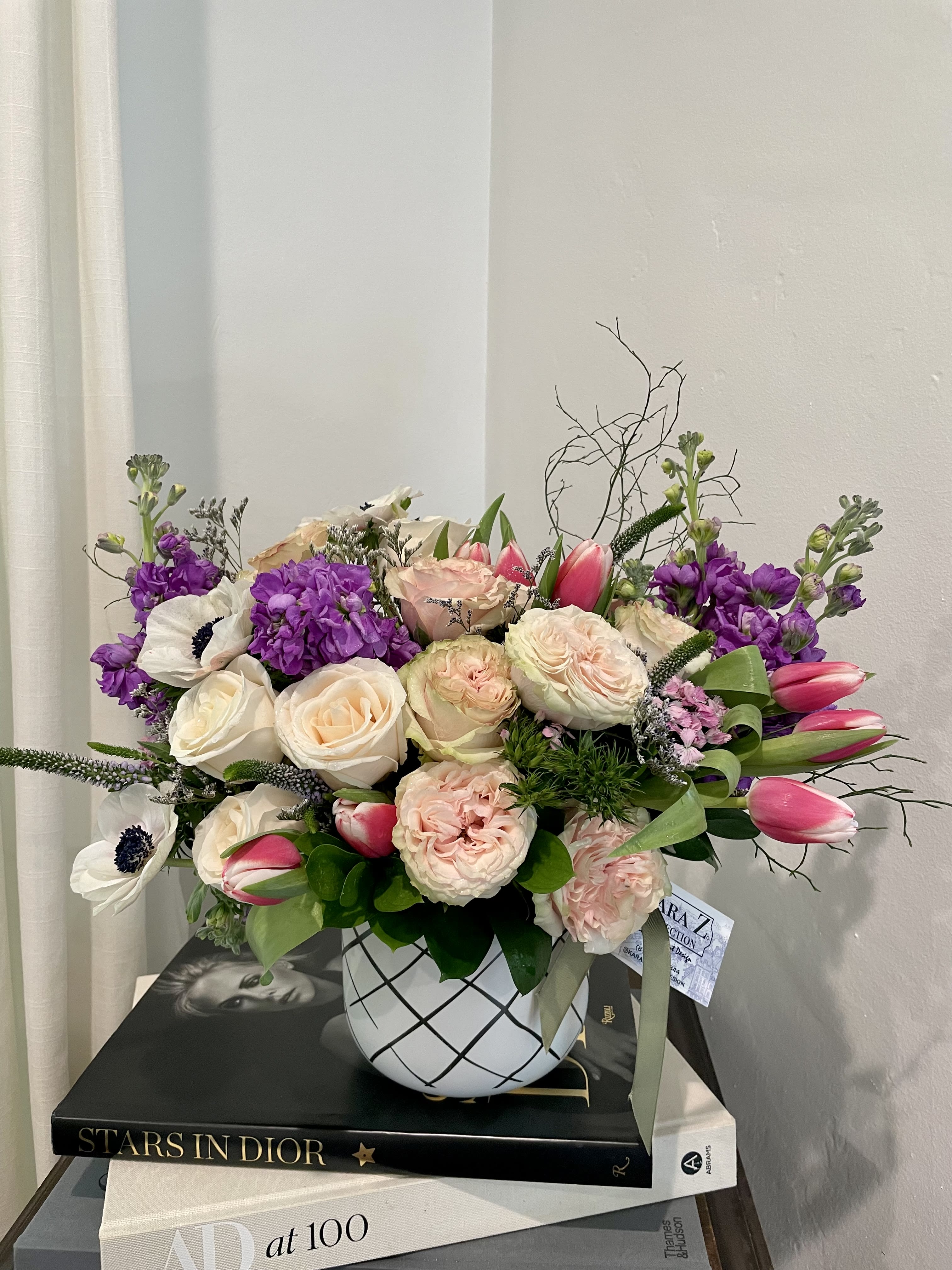 Blushing Garden - Beautiful blush roses, jeweled toned stock, and lush greens arranged with other premium and seasonal florals to create a one of a kind arrangement. Ideal for any occasion and sure to make a statement. 