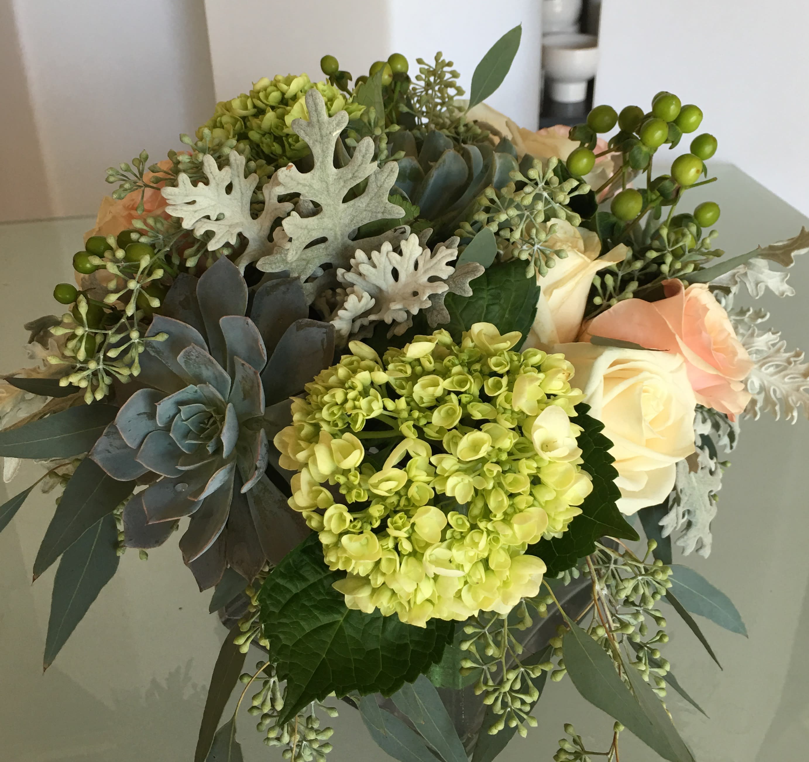 Succulents and Blooms  - Silver succulents with Dusty Miller, peach roses, green coffee beans, green hydrangeas and seeded eucalyptus