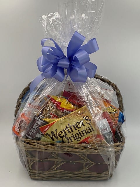 GOODY BASKET - HERE IS WHAT IS NEEDED FOR THE THAT PERSON WHO HAS A SWEET TOOTH AND IS A SNACKER. WICKER BASKET FULL OF A VARIETY OF CANDY, COOKIES, AND CHIPS