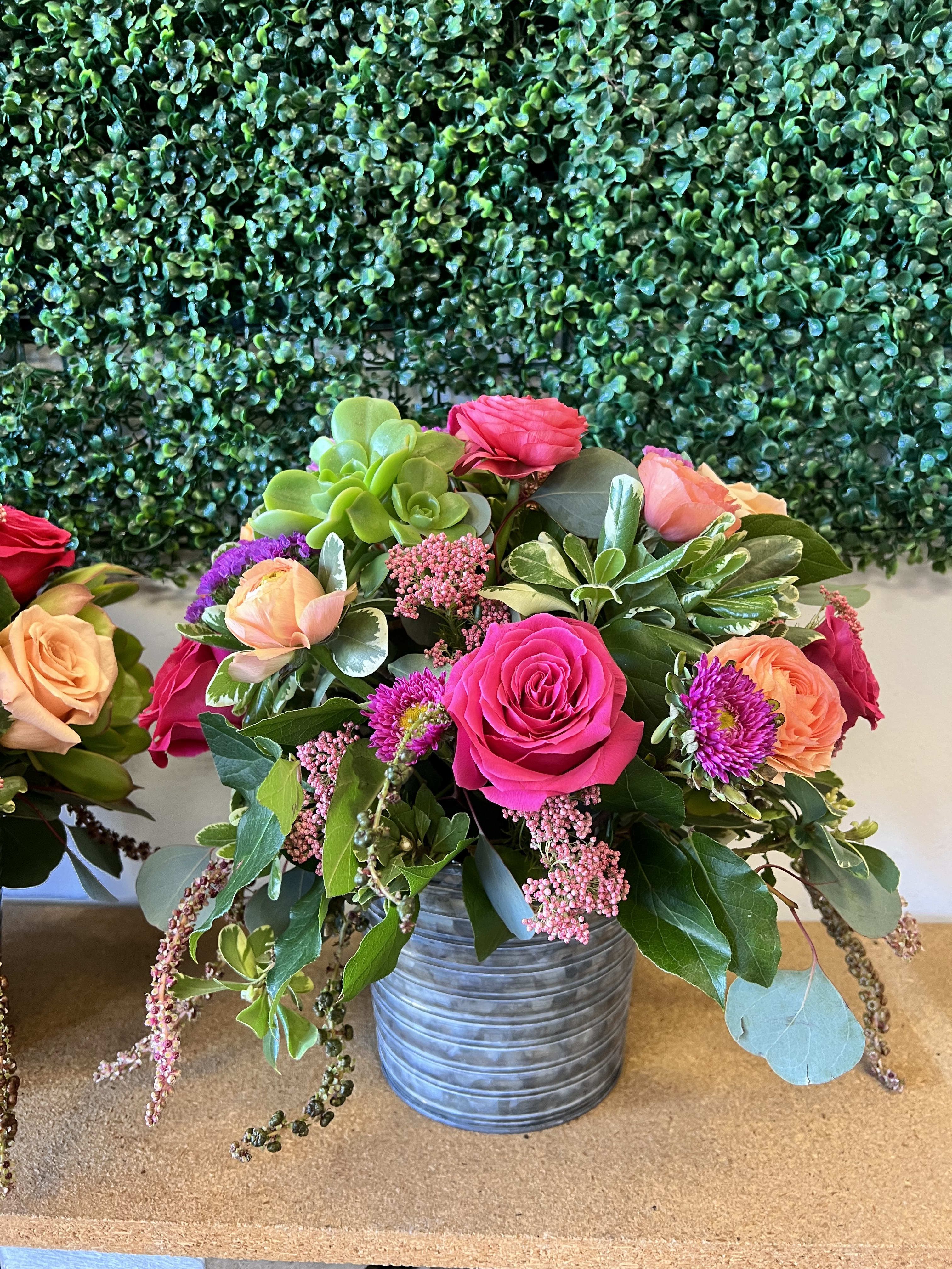 Lovely Spring Lovely Spring - Pink Ranunculus, Hot pink roses, Light pink rice flower, Succulent, Pink Matsumoto, Small Orange Ranunculus, Purple Starter