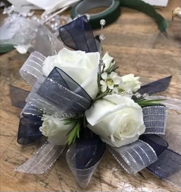 Tuxedo pair - White roses wristlet corsage and pairing’s boutonnière with tuxedo pin strips ribbons silver and black