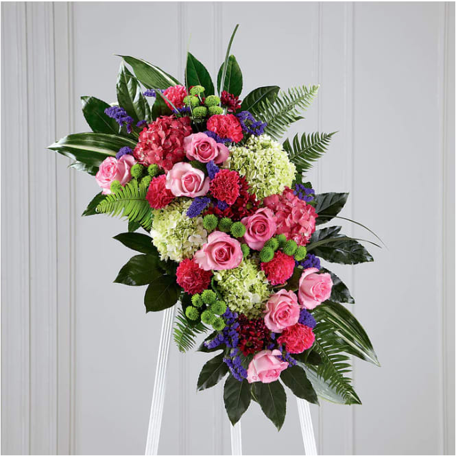 Refreshing Mix Standing Spray Refreshing Mix Standing Spray - This glorious celebration of life combines the vibrant, hopeful colors of spring in a standing arrangement designed to inspire happy memories of times gone by. Handcrafted by our artisan florists of bright and beautiful blossoms that include pink roses, magenta carnations, purple statice and hydrangeas, green button pompons and hydrangeas and daisy pompons all arranged against a background of lush green aralia and aspidistra leaves. DETAILS 40"h x 23"w