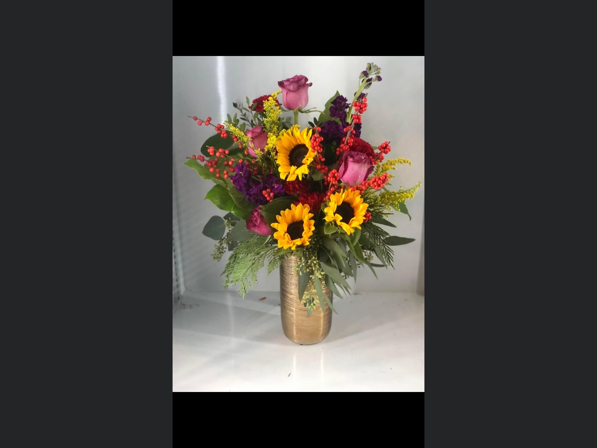 Sweet Fall - A mixture of winter of oranges, reds, golds in a medium tall gold vase