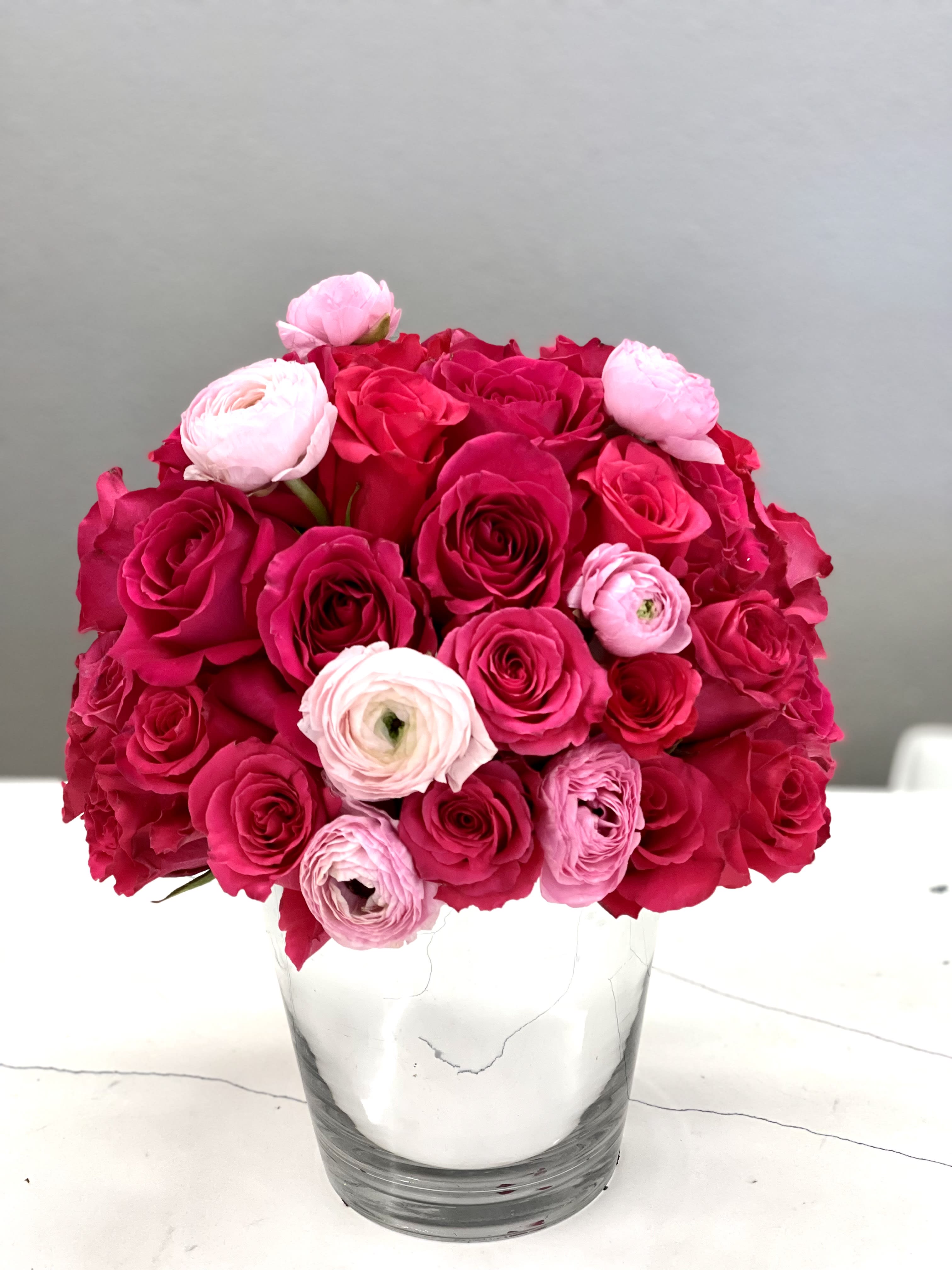 The flower of love - Brighten her day with this gorgeous 3 dozen hot pink roses and ranunculus bouquet.