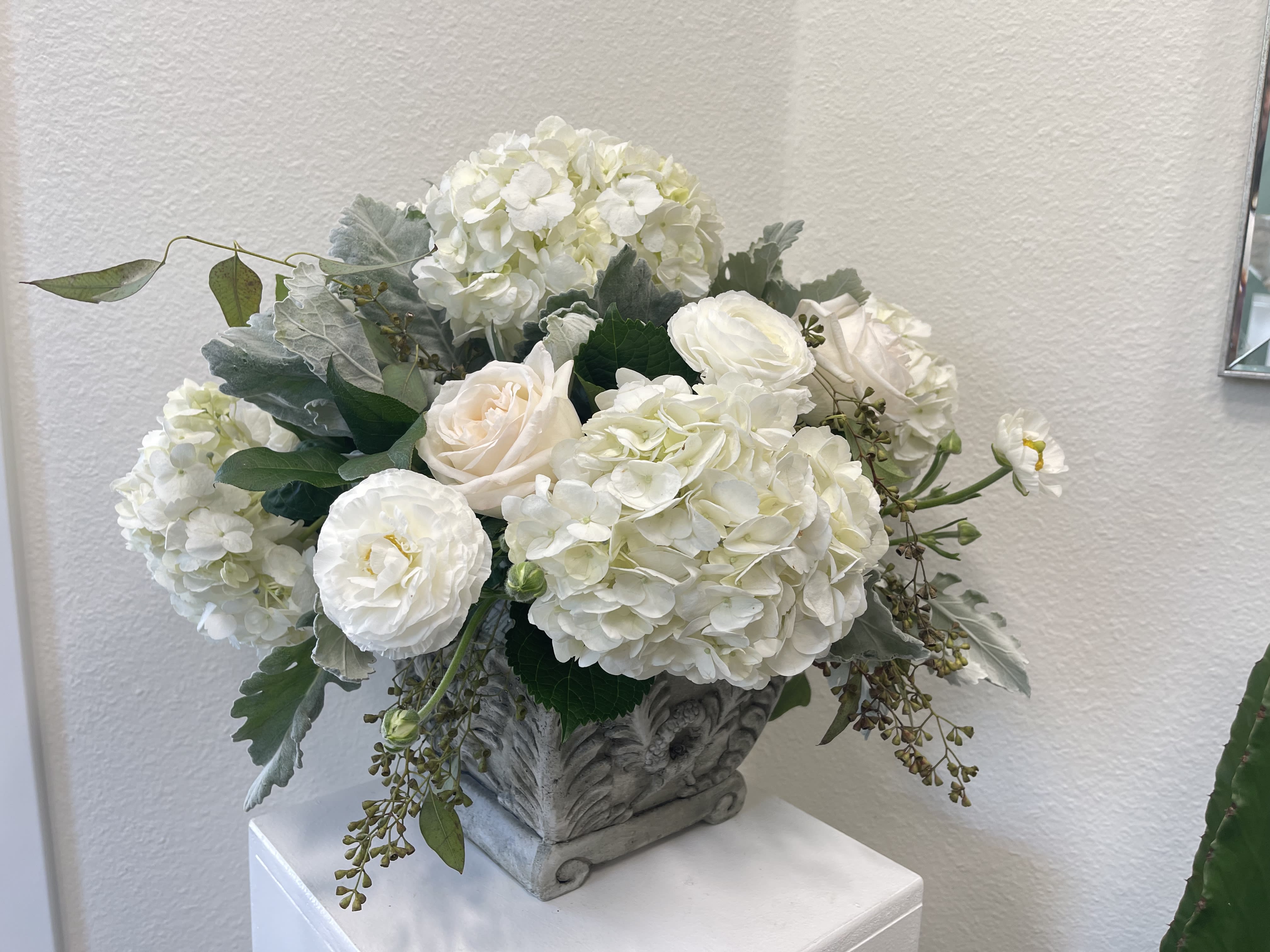 French Countryside - A substantial arrangement of white and cream Flowers set with local greenery in a gorgeous keepsake pot.