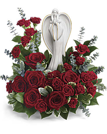 Forever Our Angel Bouquet by Teleflora - This peaceful porcelain angel sculpture, surrounded by radiant red roses and delicate greenery, is a touching tribute to a rich life. This radiant bouquet includes red roses, red spray roses, spiral eucalyptus, variegated pittosporum, and lemon leaf. Delivered with an Angel of Grace Keepsake.